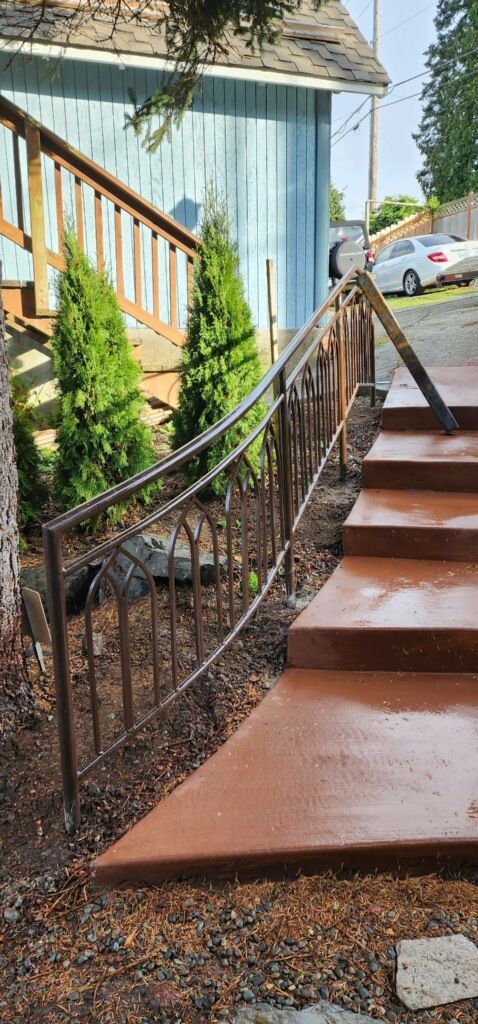 A set of stairs leading up to a house with a railing