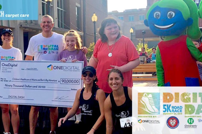 A group of people standing next to each other holding a large check.