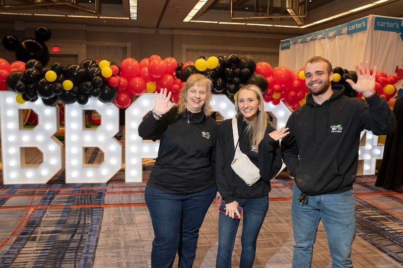 A group of people are standing in front of a sign that says bbc.