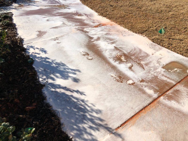 A concrete sidewalk with a shadow of a tree on it