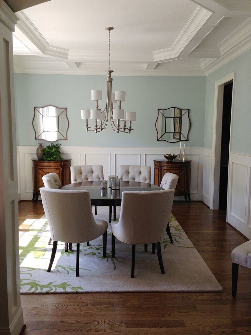 A dining room with a table and chairs and a chandelier