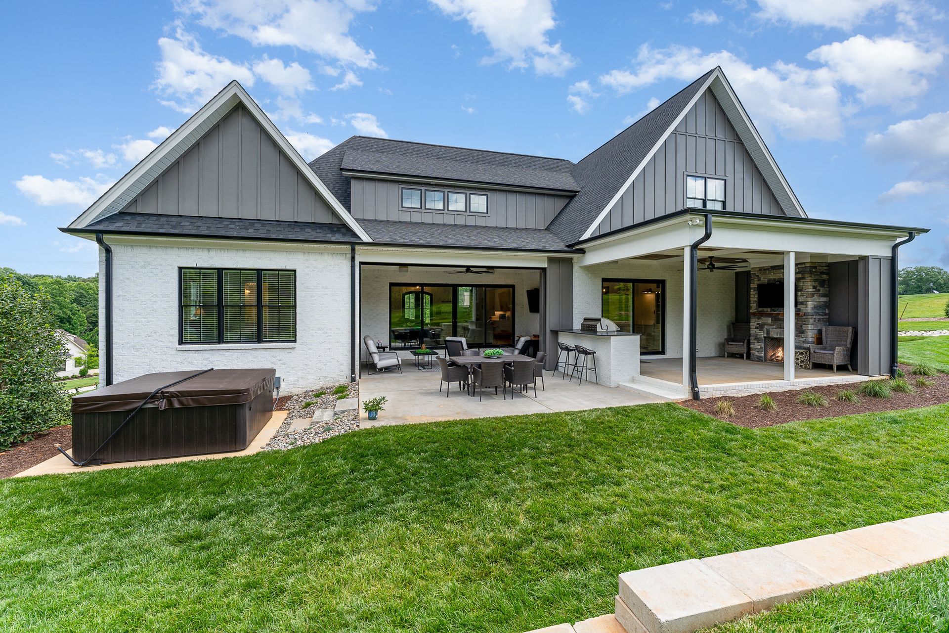 The back of a house with a patio and a hot tub