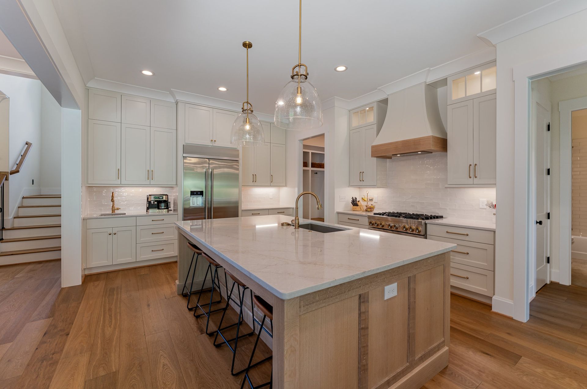 The Dreamscape kitchen with white cabinets and stainless steel appliances