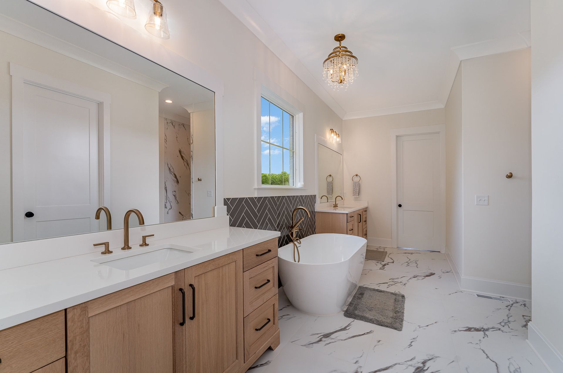 The Dreamscape bathroom with a tub, sink, and mirror
