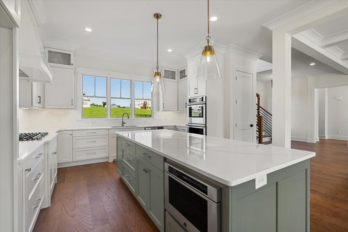 A kitchen with a large island in the middle