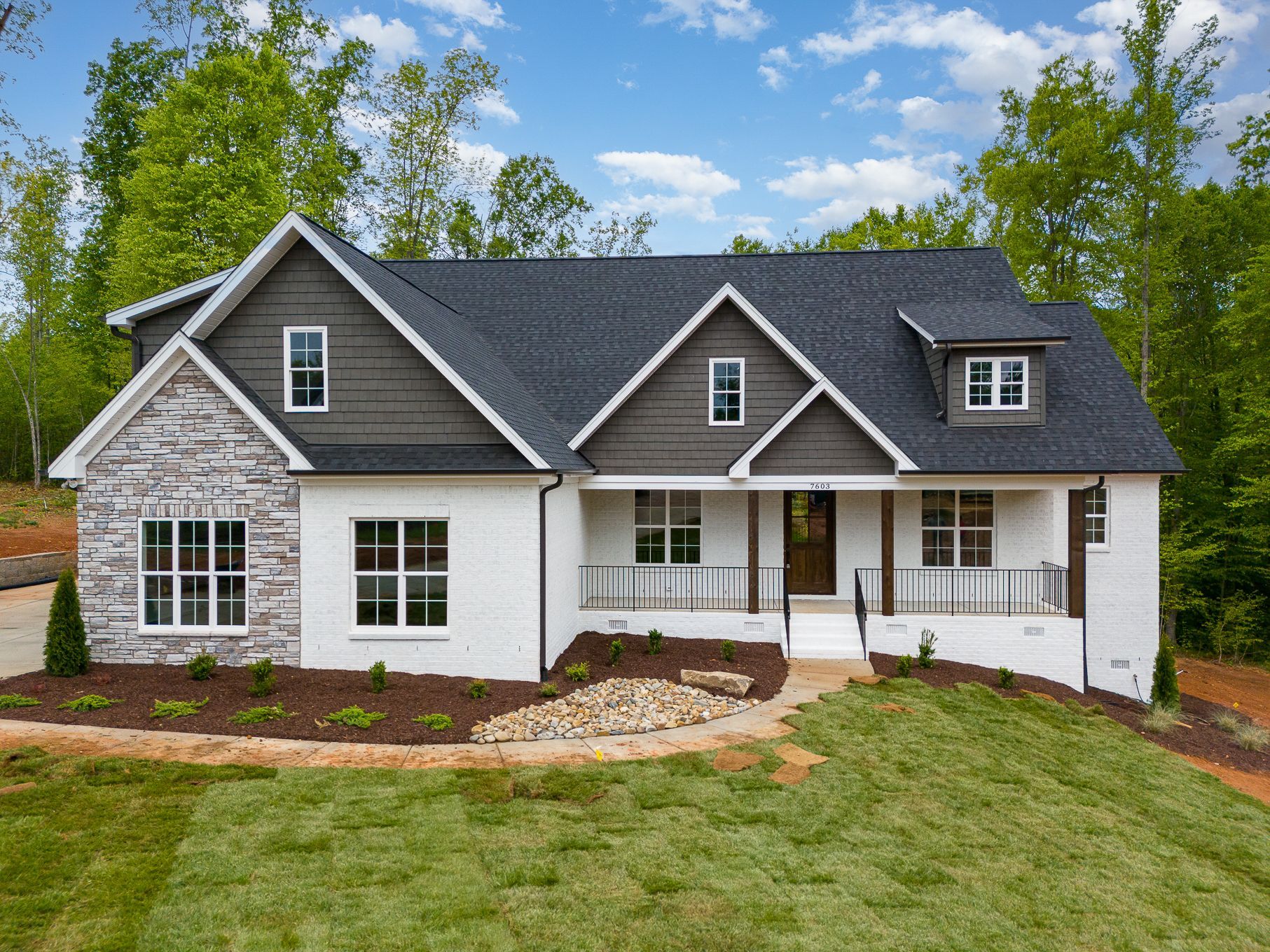 A large white house with a gray roof