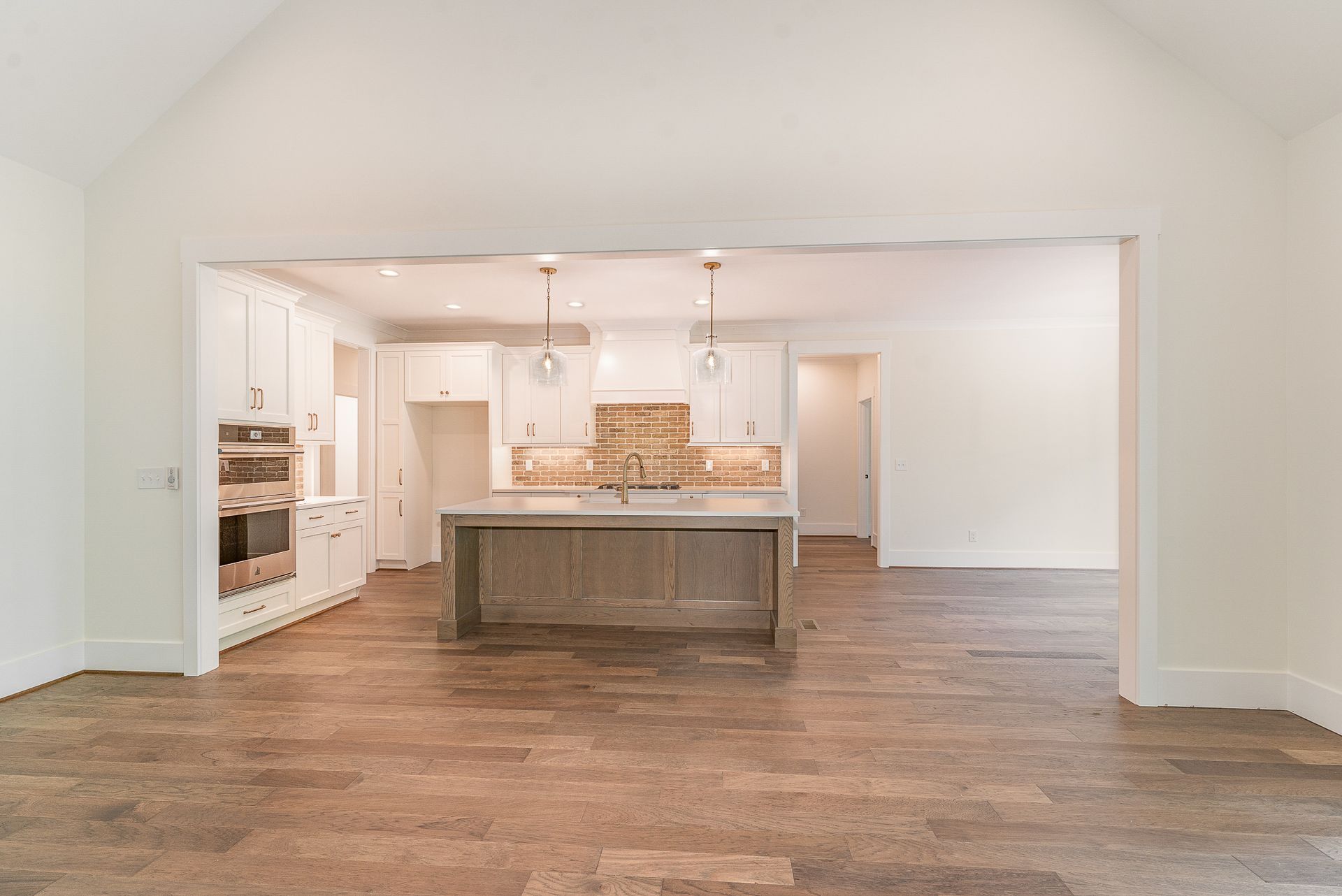 An empty kitchen with a large island in the middle of the room