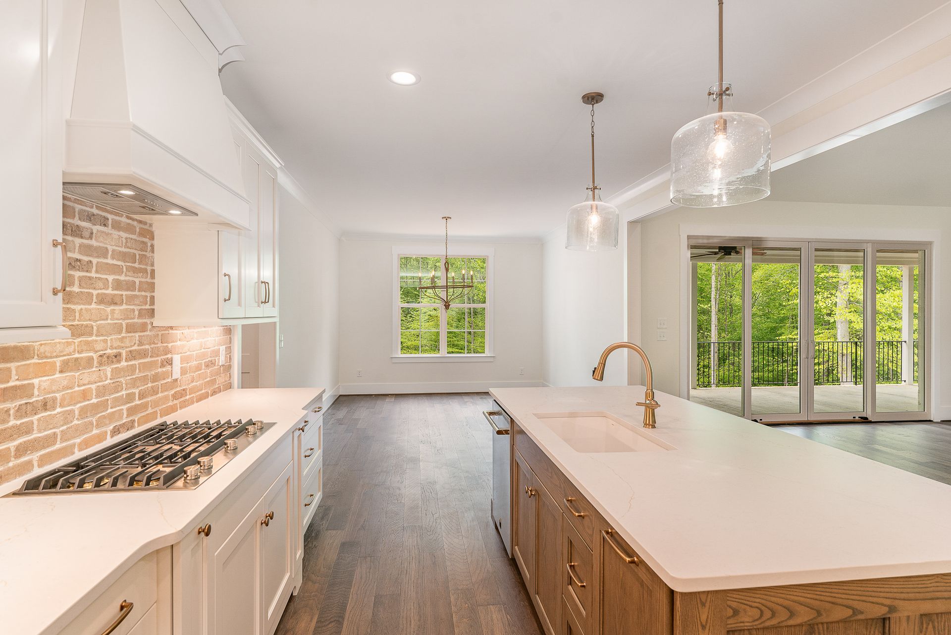 A kitchen with a large island and a stove-top oven