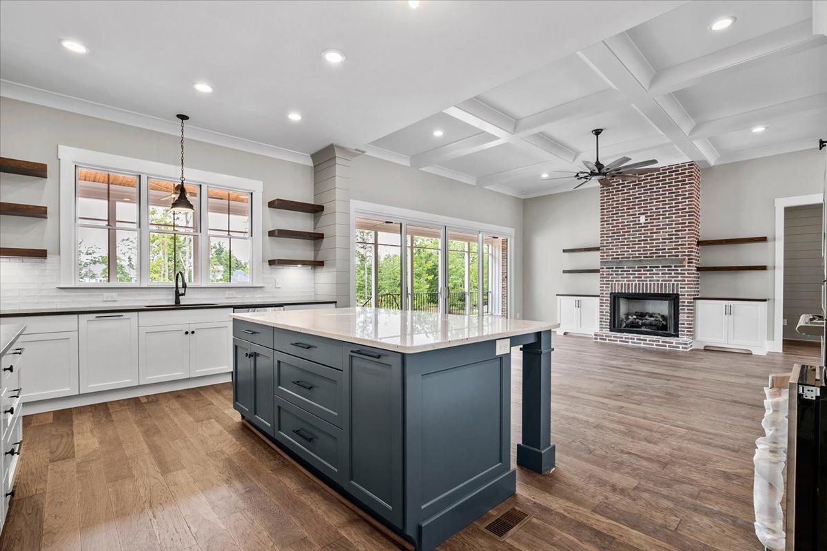 A kitchen with a large island and a fireplace