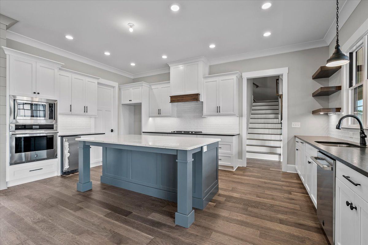 Kitchen with cabinets and a blue island in the middle
