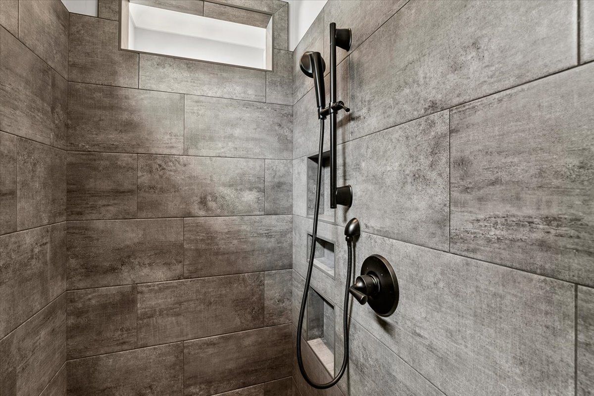 A bathroom with a showerhead