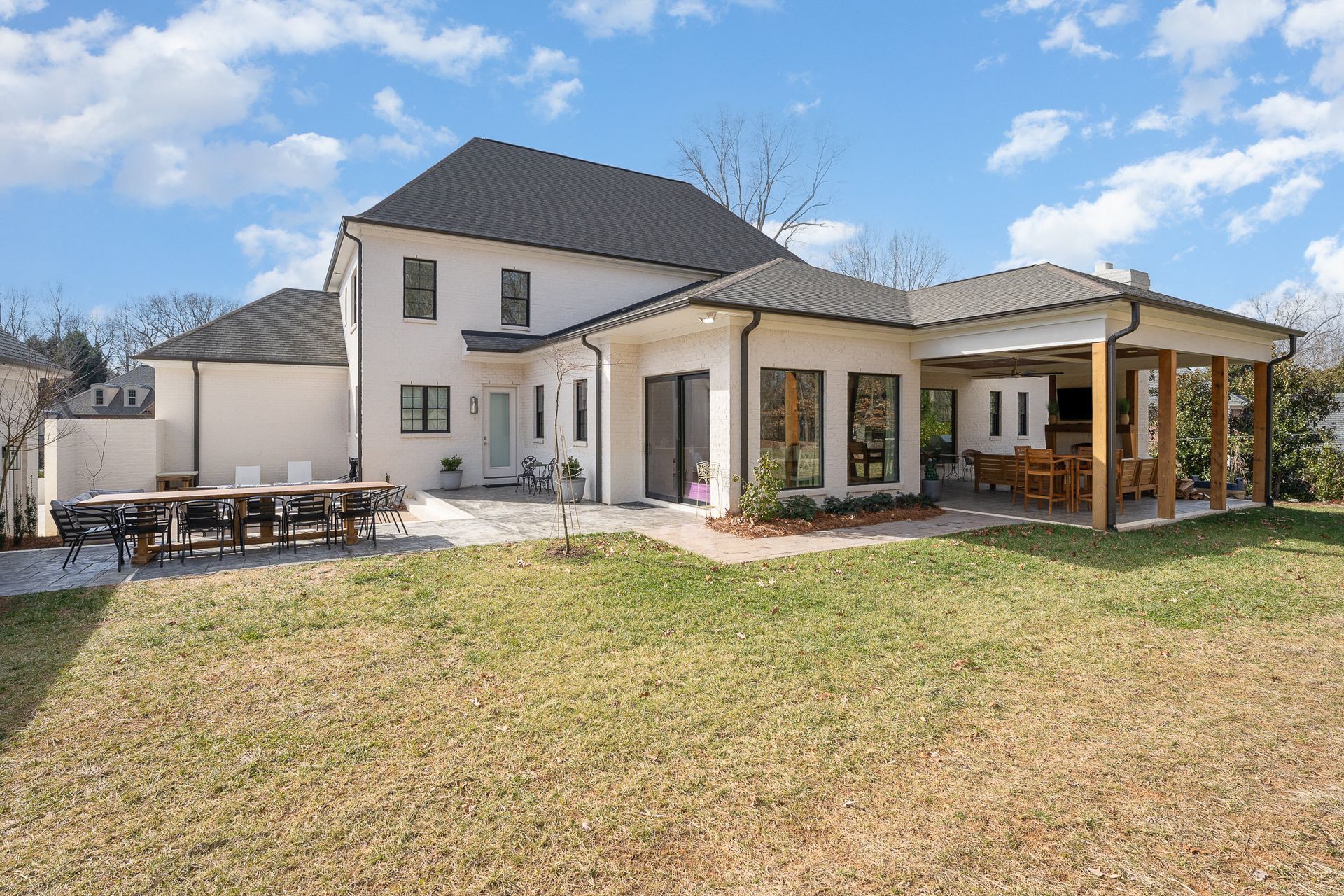 A large white house with a large lawn in front of it