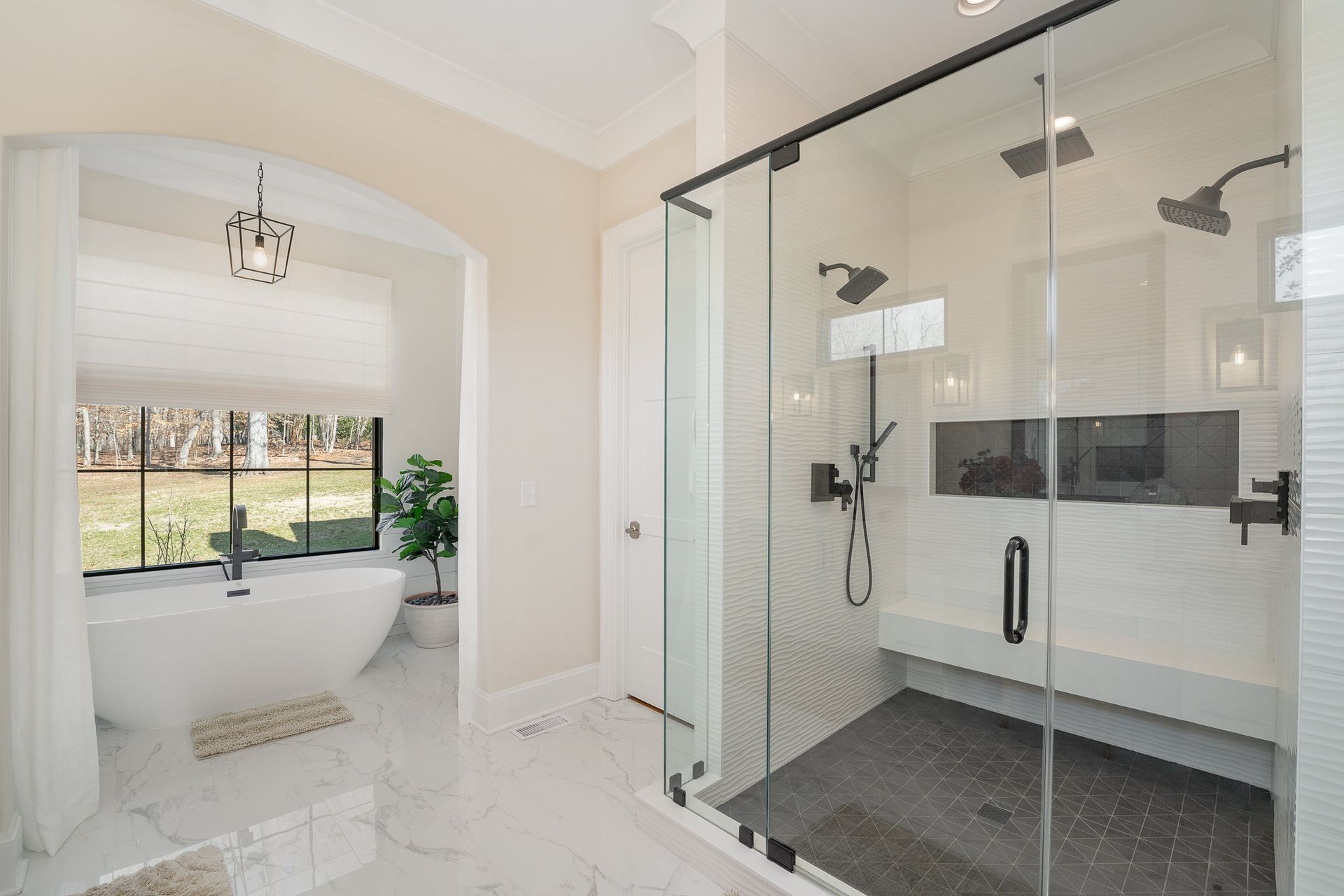 A bathroom with a walk-in shower and a bathtub