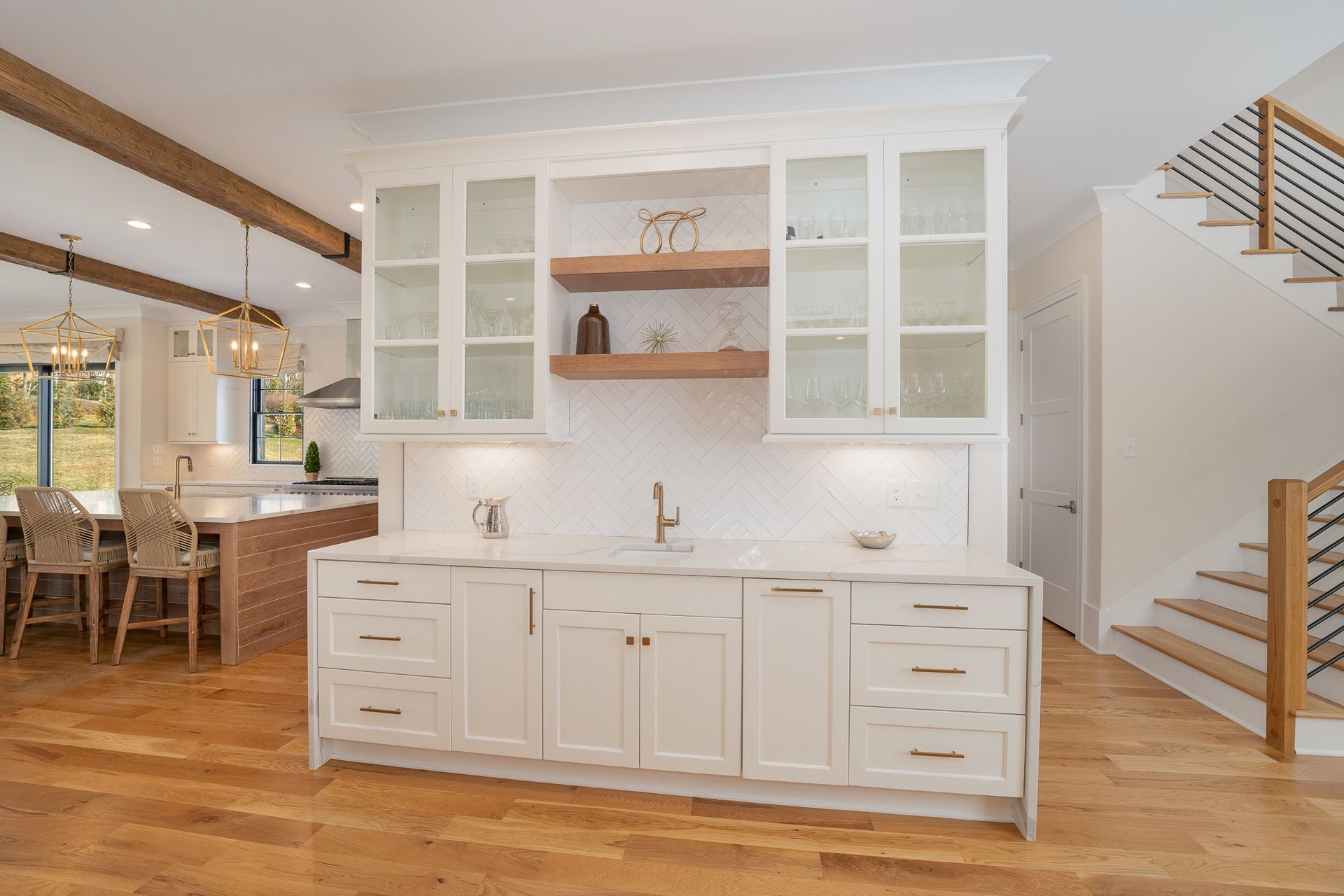 A kitchen with white cabinets and a sink