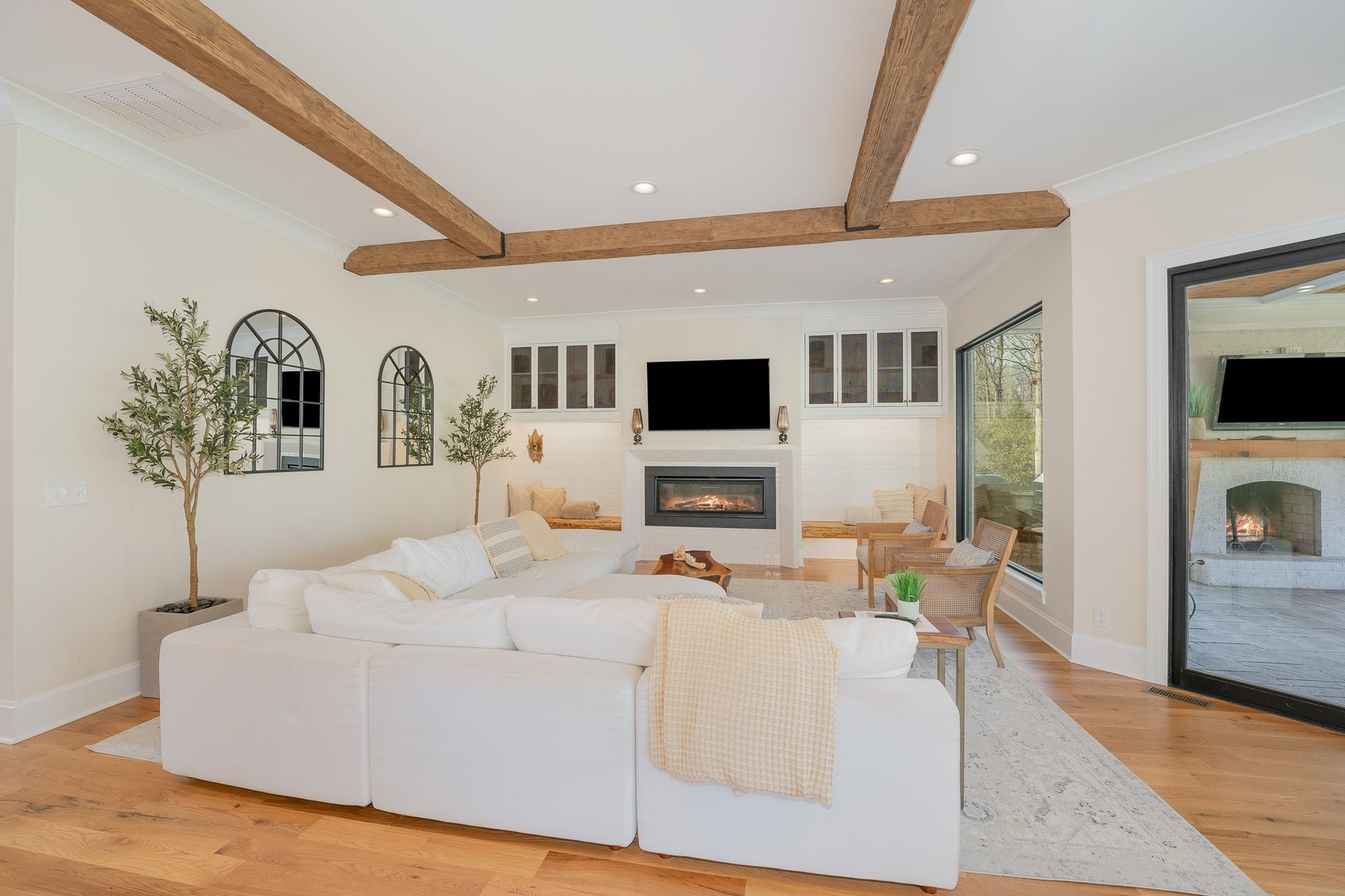 A living room with a white couch and a fireplace