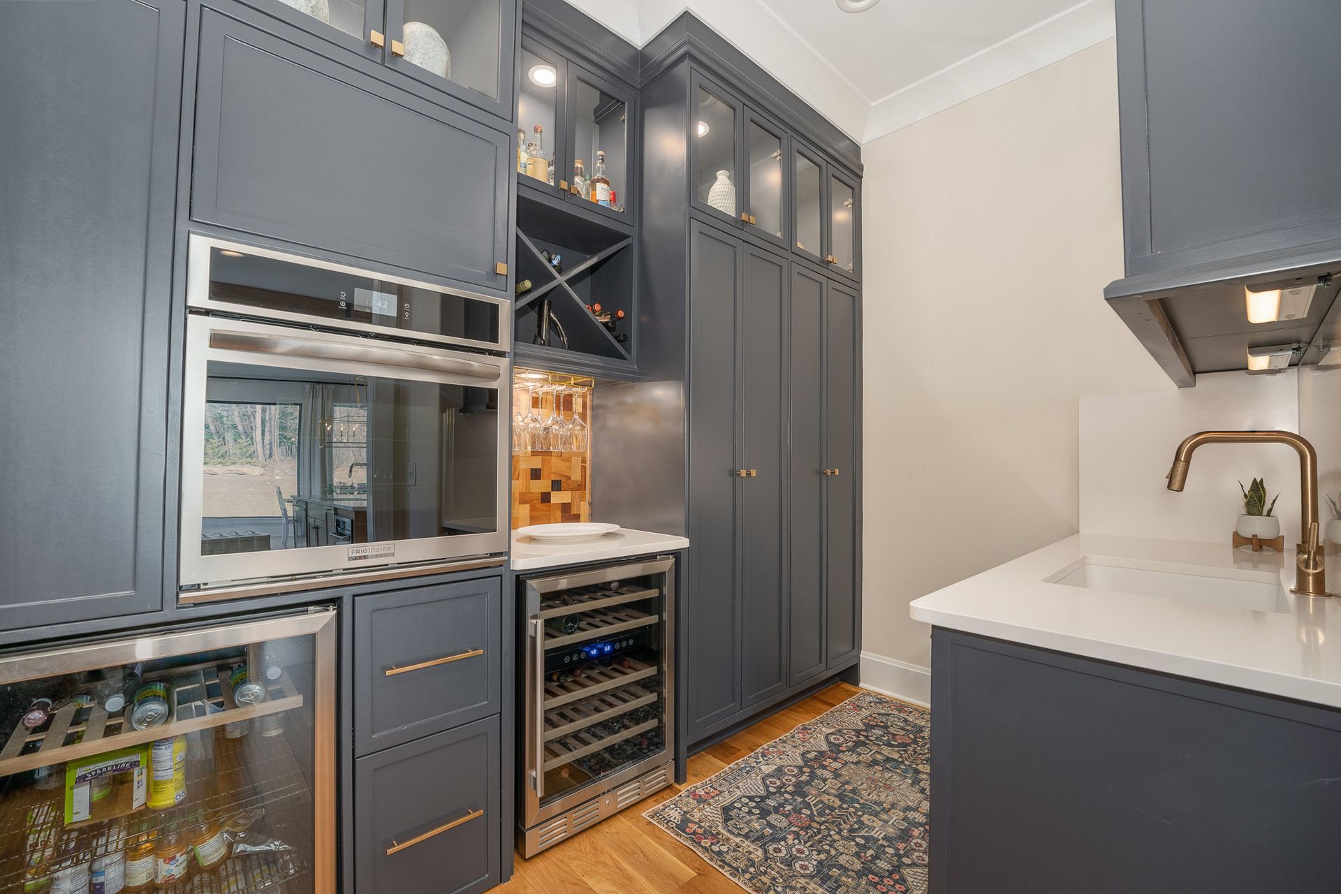 A kitchen with stainless steel appliances and a wine cooler