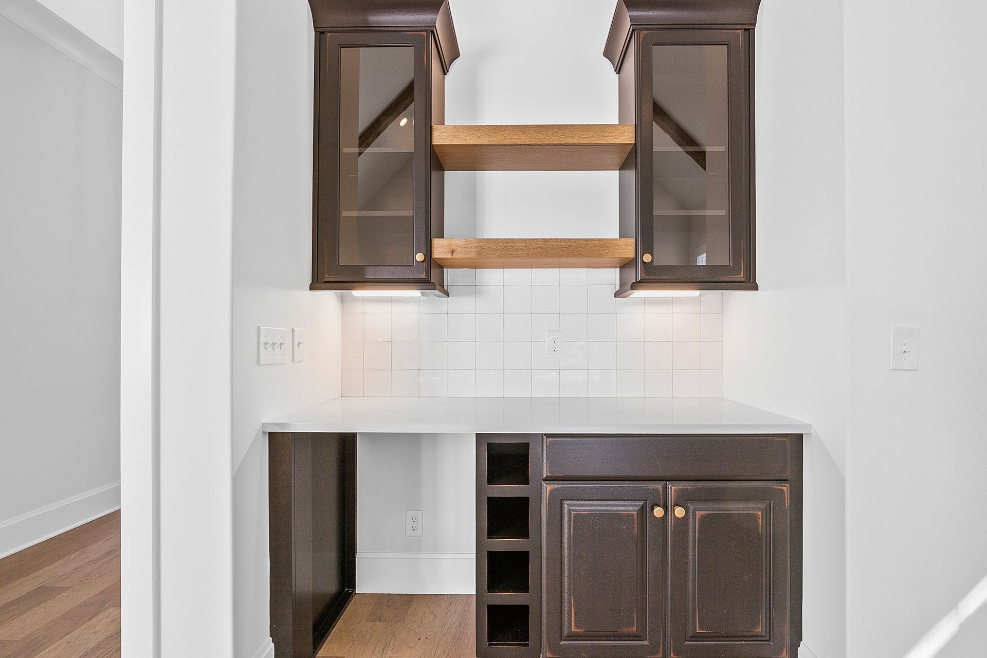 A kitchen with brown cabinets and a wine rack