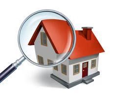 A magnifying glass focusing on a white house with a red roof.
