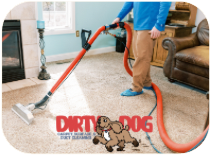 A man is using a vacuum cleaner to clean a carpet in a living room.
