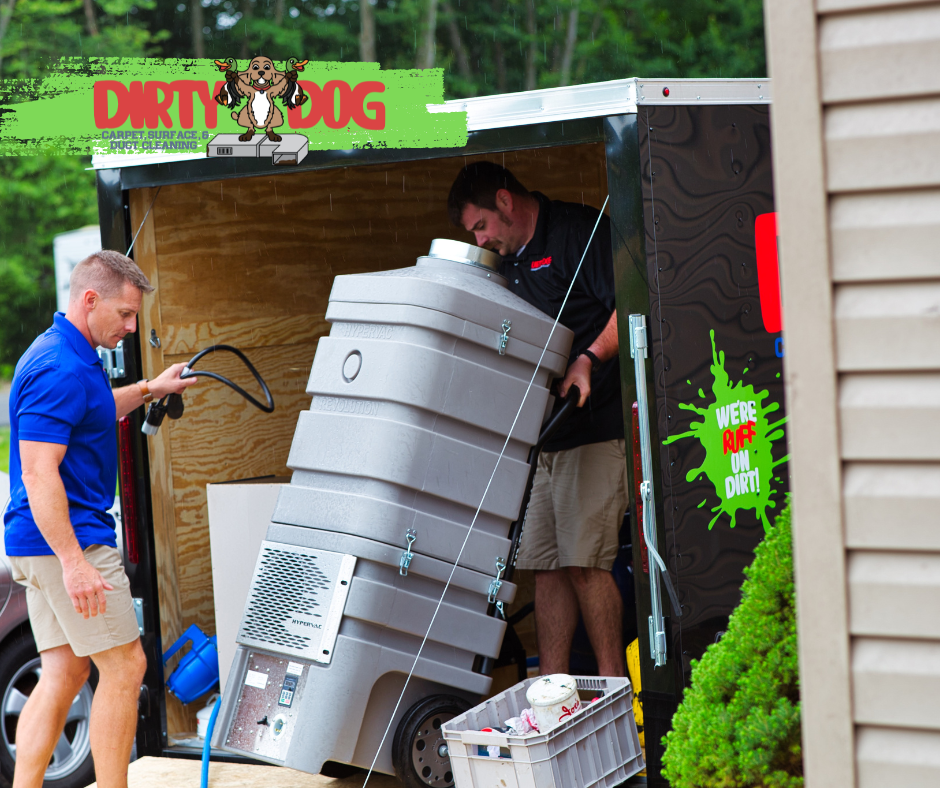 Two men are unloading a dirty dog trailer