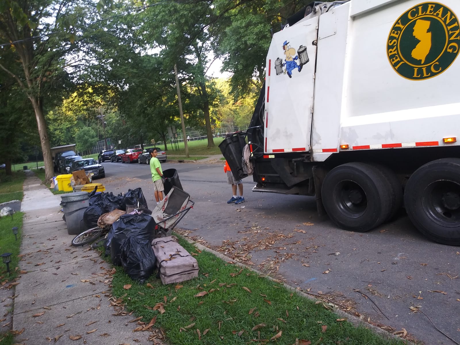 A garbage truck with a new jersey logo on the back