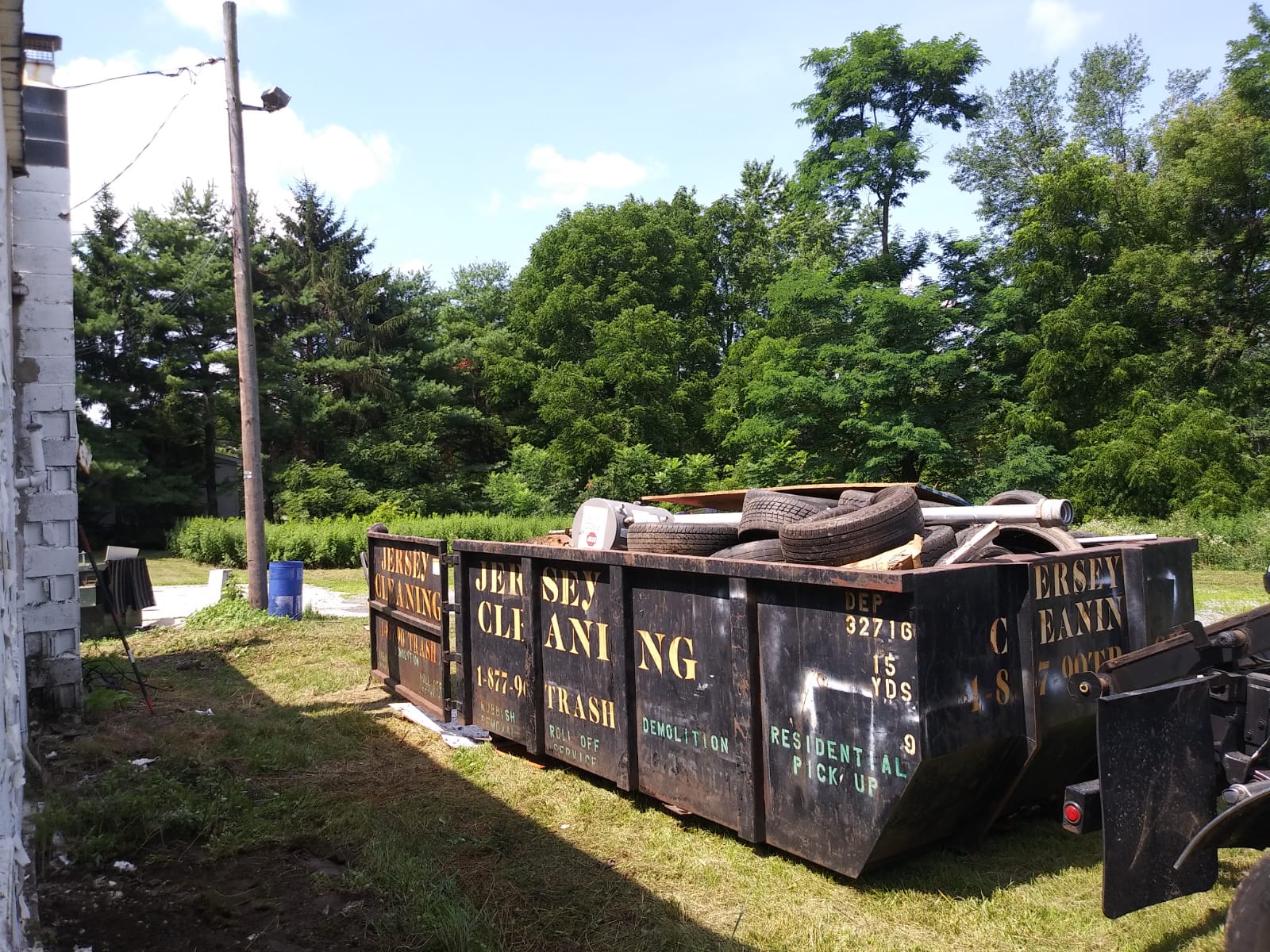 A dumpster labeled with Jersey Cleaning.