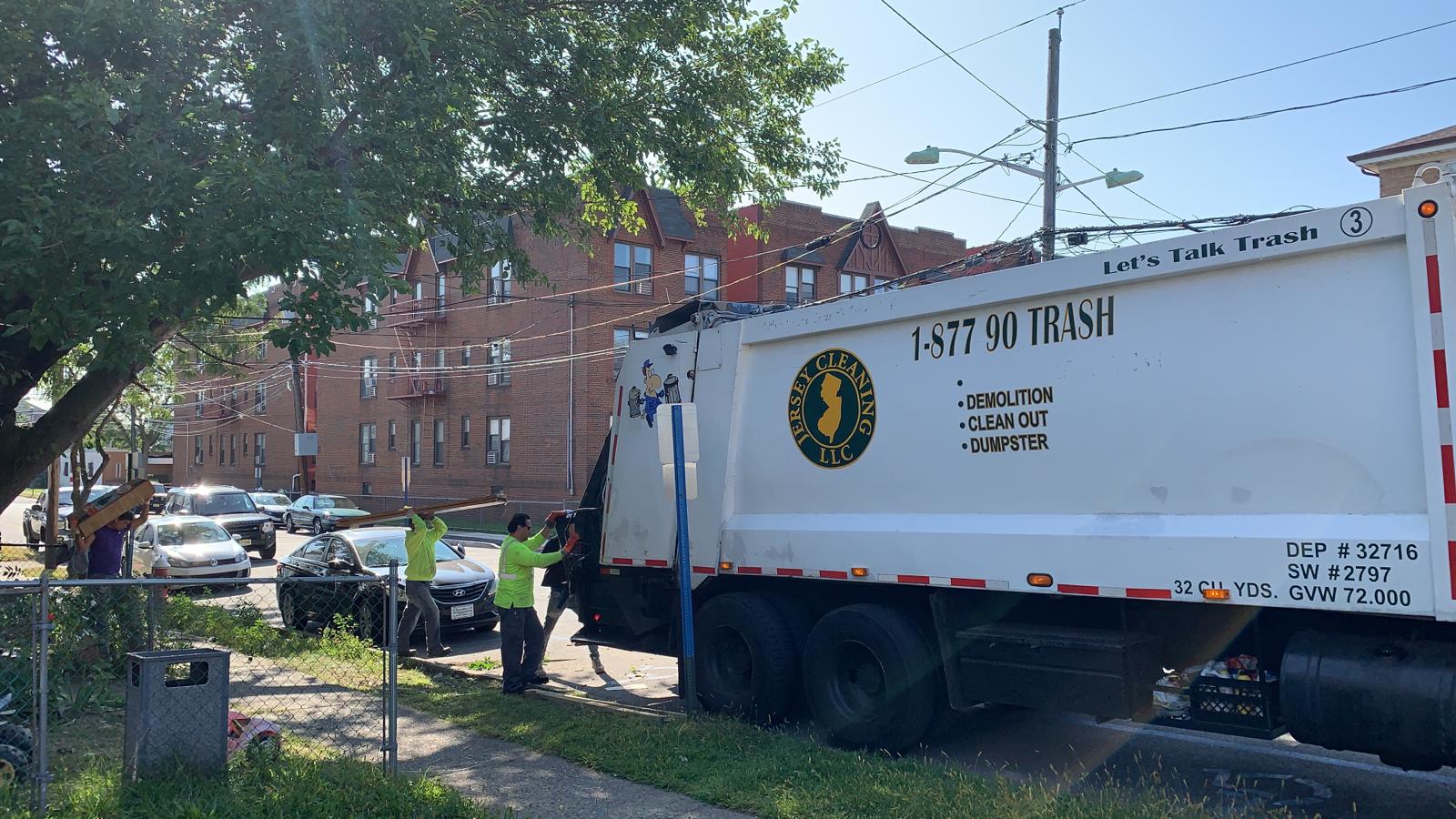 Jersey Cleaning truck collecting garbage.