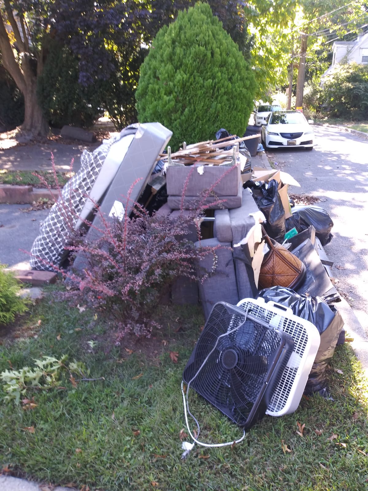 A pile of trash is sitting on the side of the road.