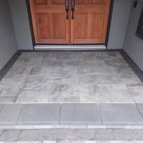 A doorway with a tiled floor and steps leading to it.