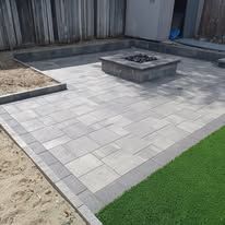 There is a fire pit in the middle of the patio.