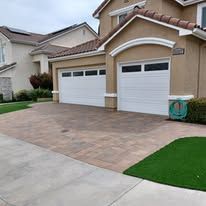 A large house with two garage doors and a driveway.