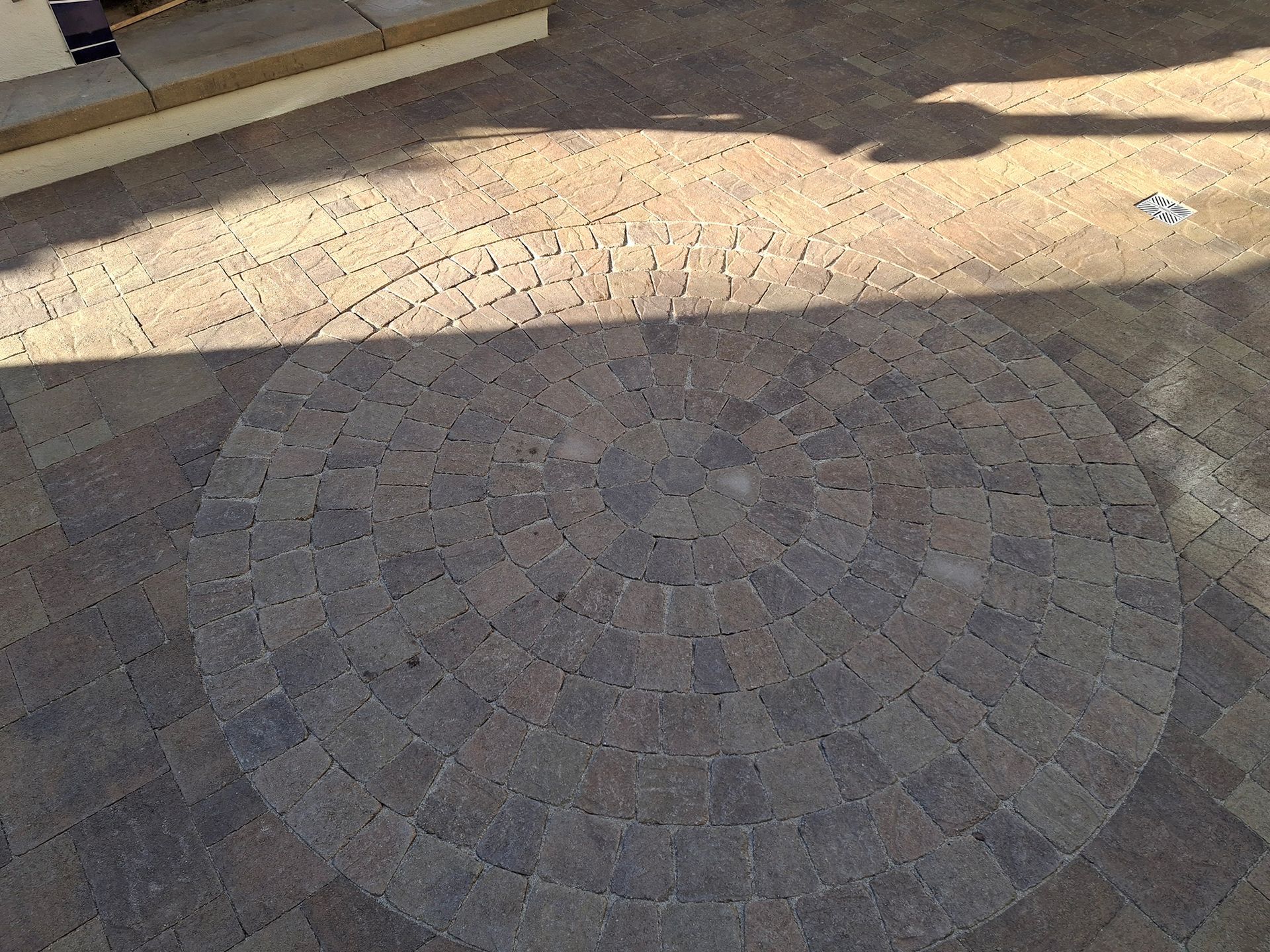A circular pattern of bricks on the ground