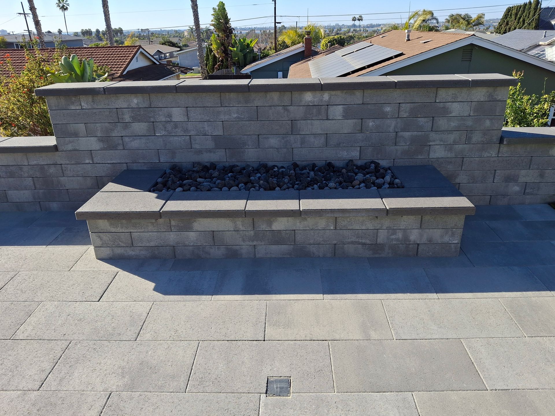 A brick wall with a fire pit in the middle of it