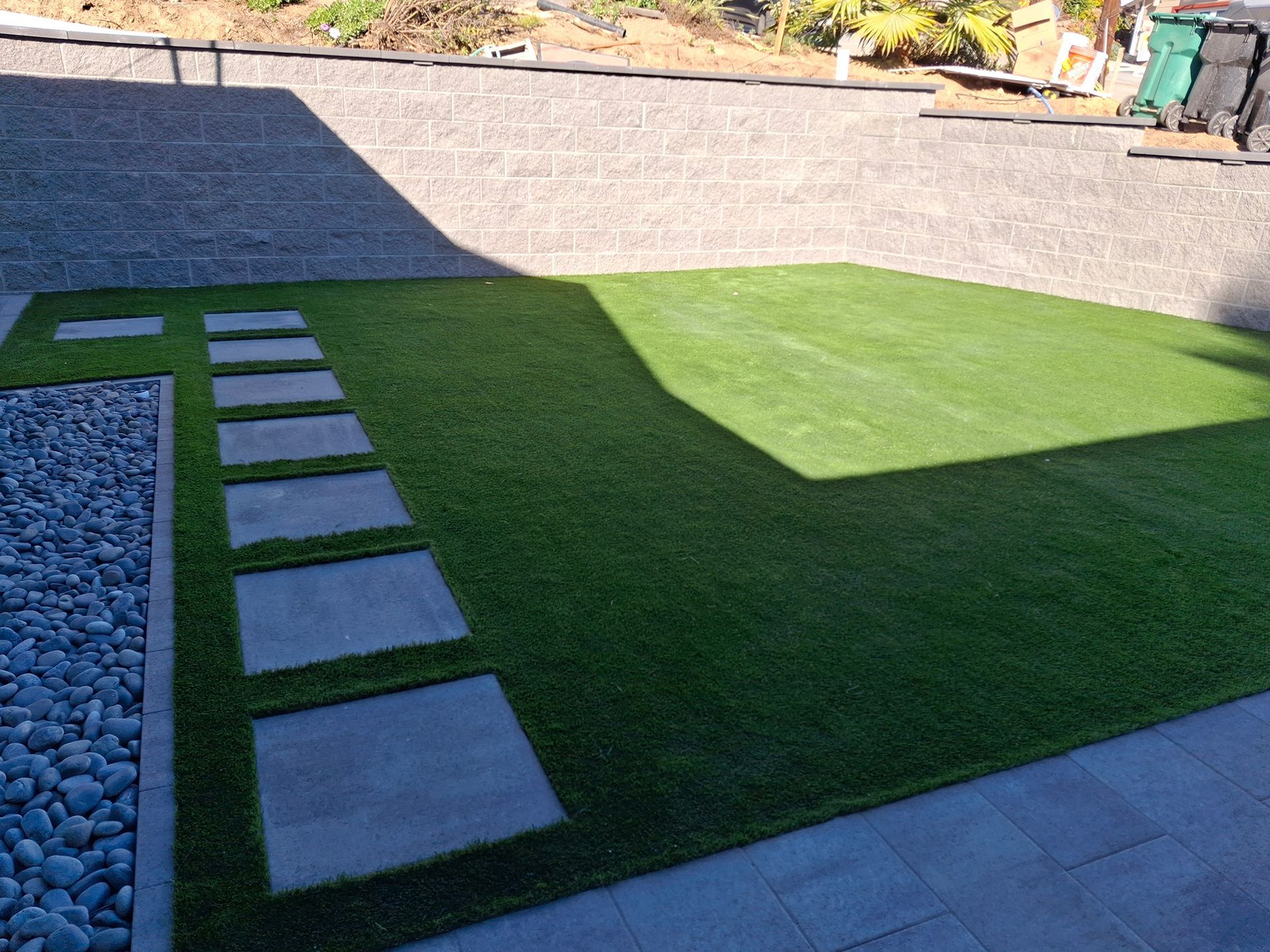 A lawn with a concrete walkway leading to it