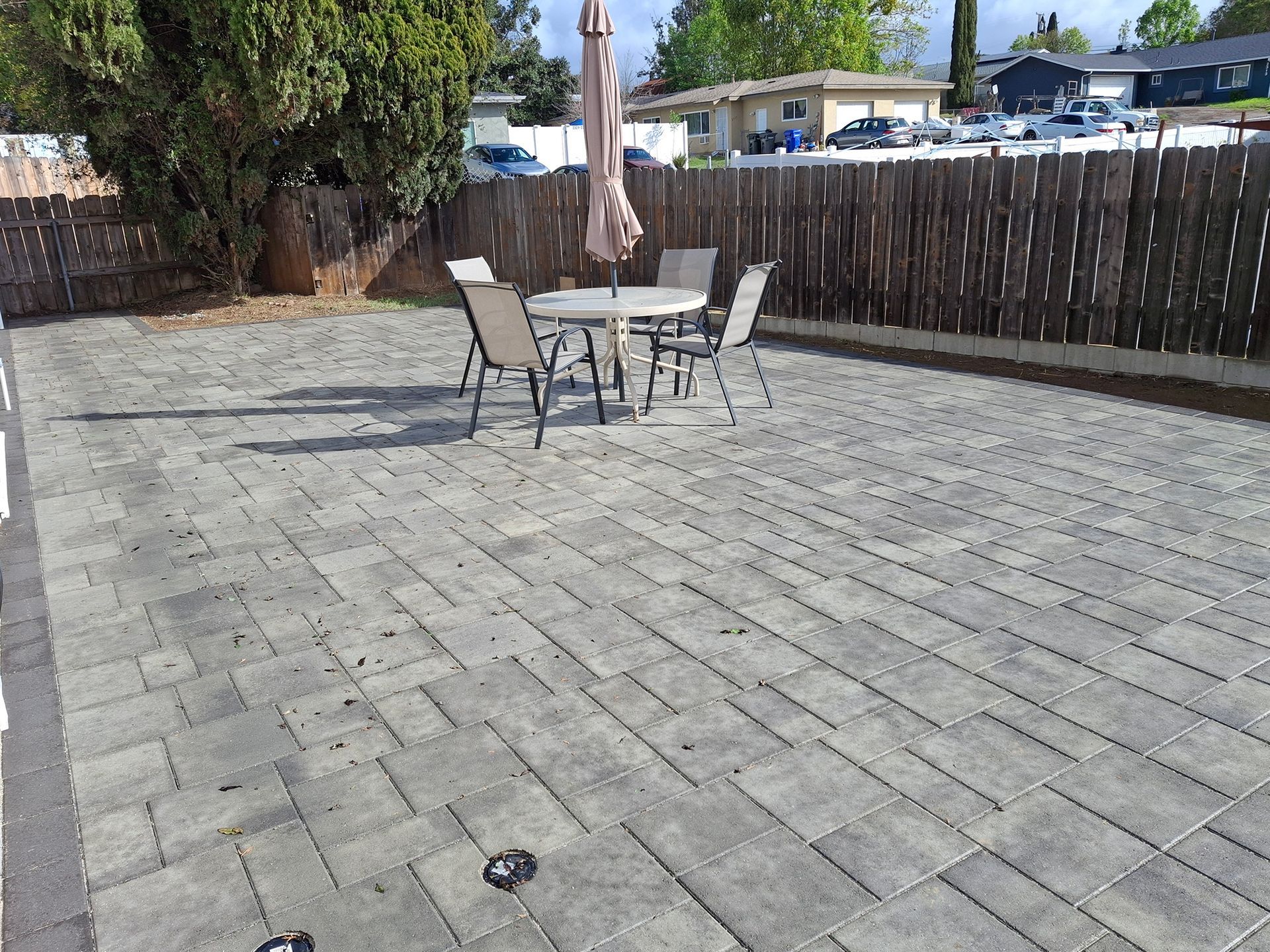A patio with a table and chairs and an umbrella