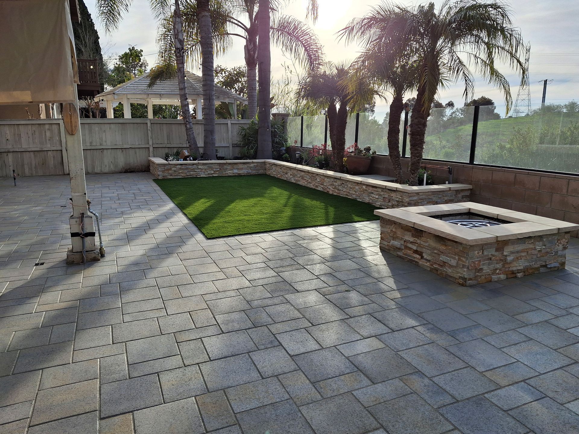 There is a fire pit in the middle of the patio.