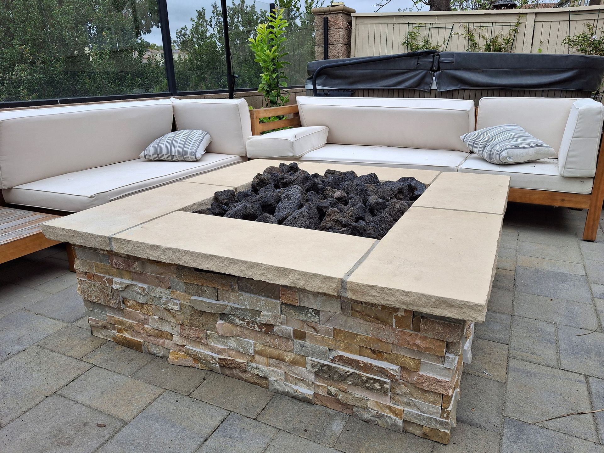 There is a fire pit in the middle of the patio.