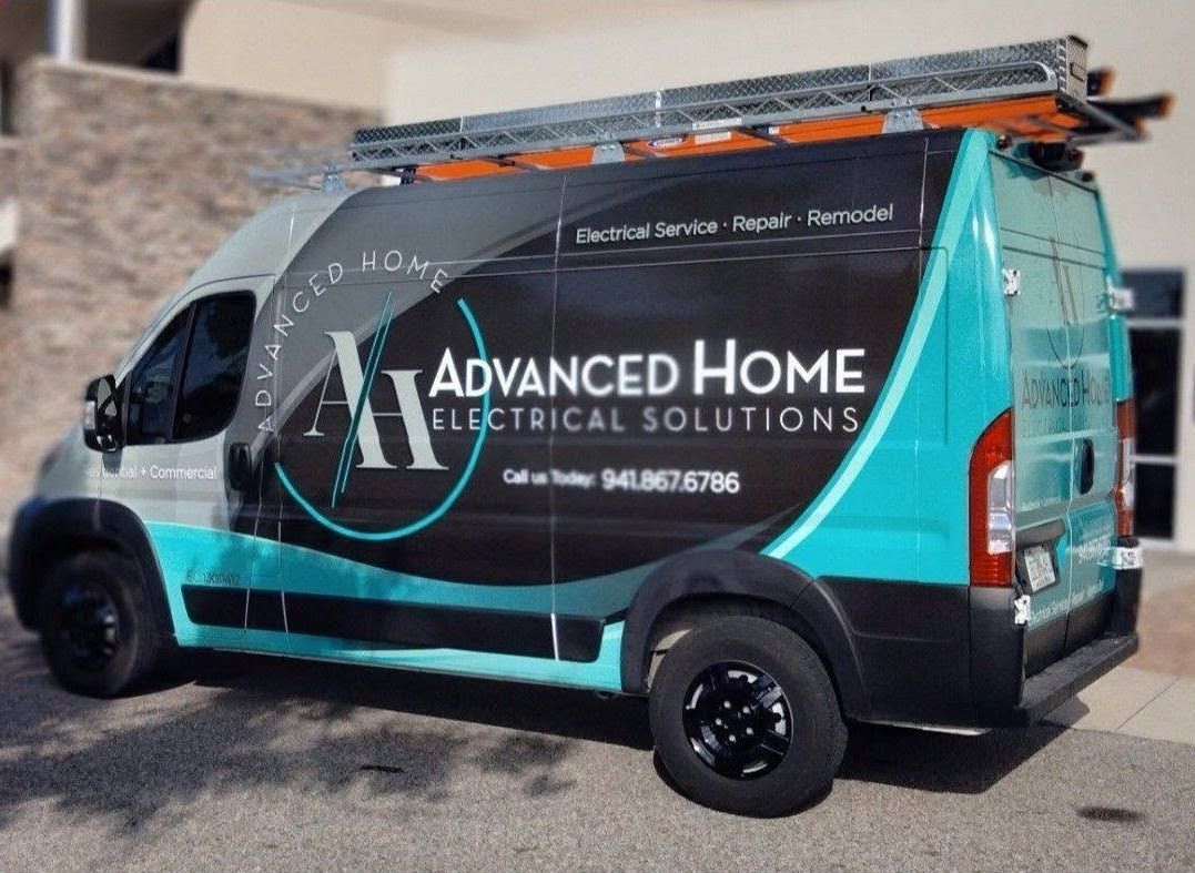 Teal and black Advanced Home Electrical Solutions van with ladder on top, parked outdoors.