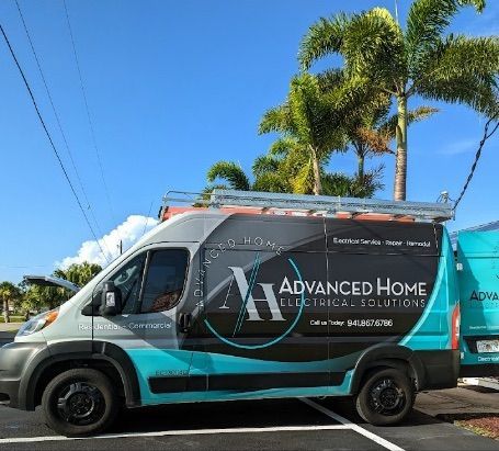Black-and-teal Advanced Home Electrical & Lighting van parked outdoors under a blue sky