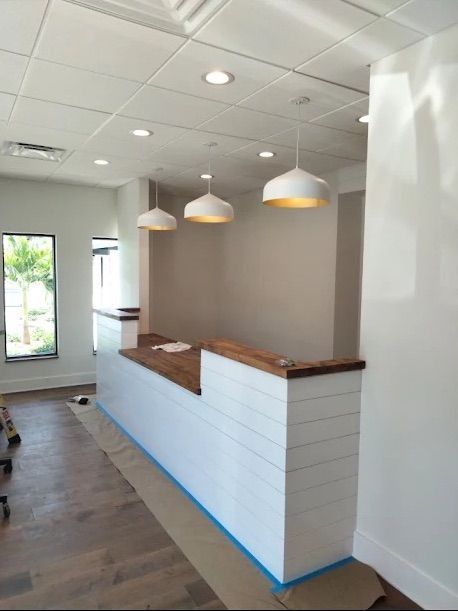 Empty modern café counter with white pendant lights and wood accents