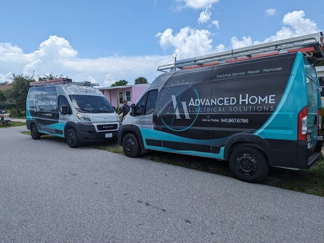 Two teal-and-gray service vans parked on gravel under a blue sky, one labeled Advanced Home Care Services
