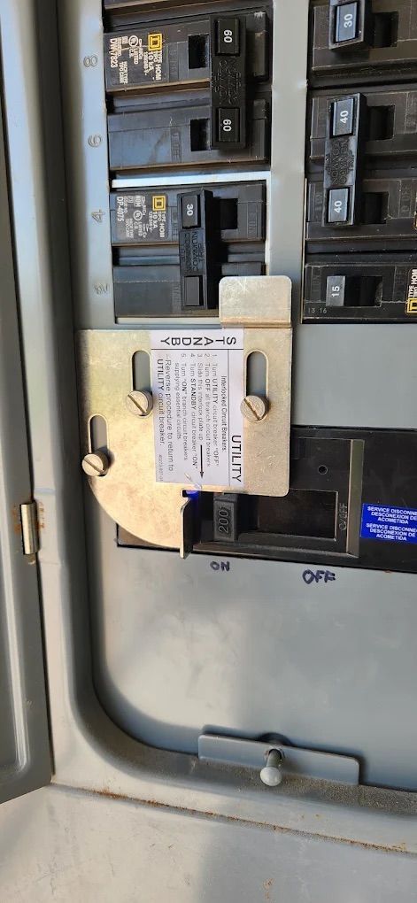 Close-up of an electrical panel with a beige lockout device on the main switch.