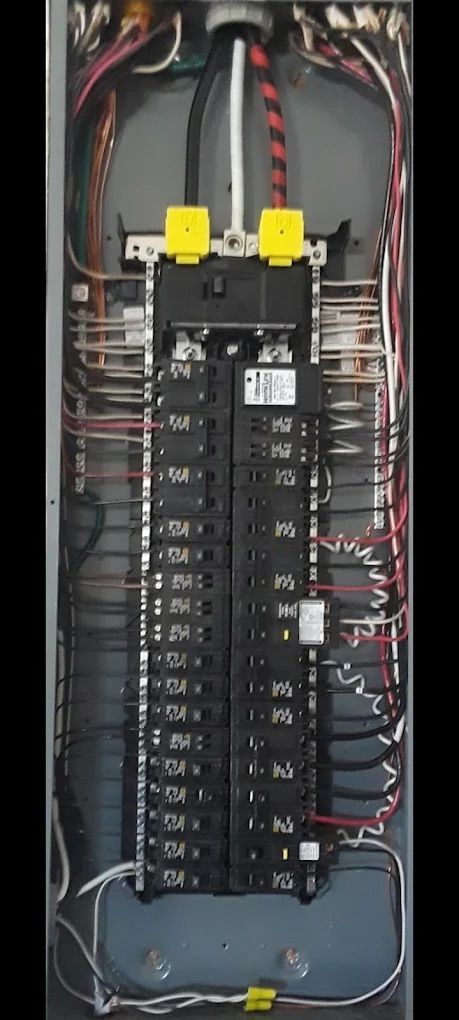 Open electrical control panel with breaker switches, wiring, and terminal blocks inside a metal cabinet