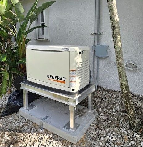 Generac backup generator on a concrete stand beside a house and shrubs.