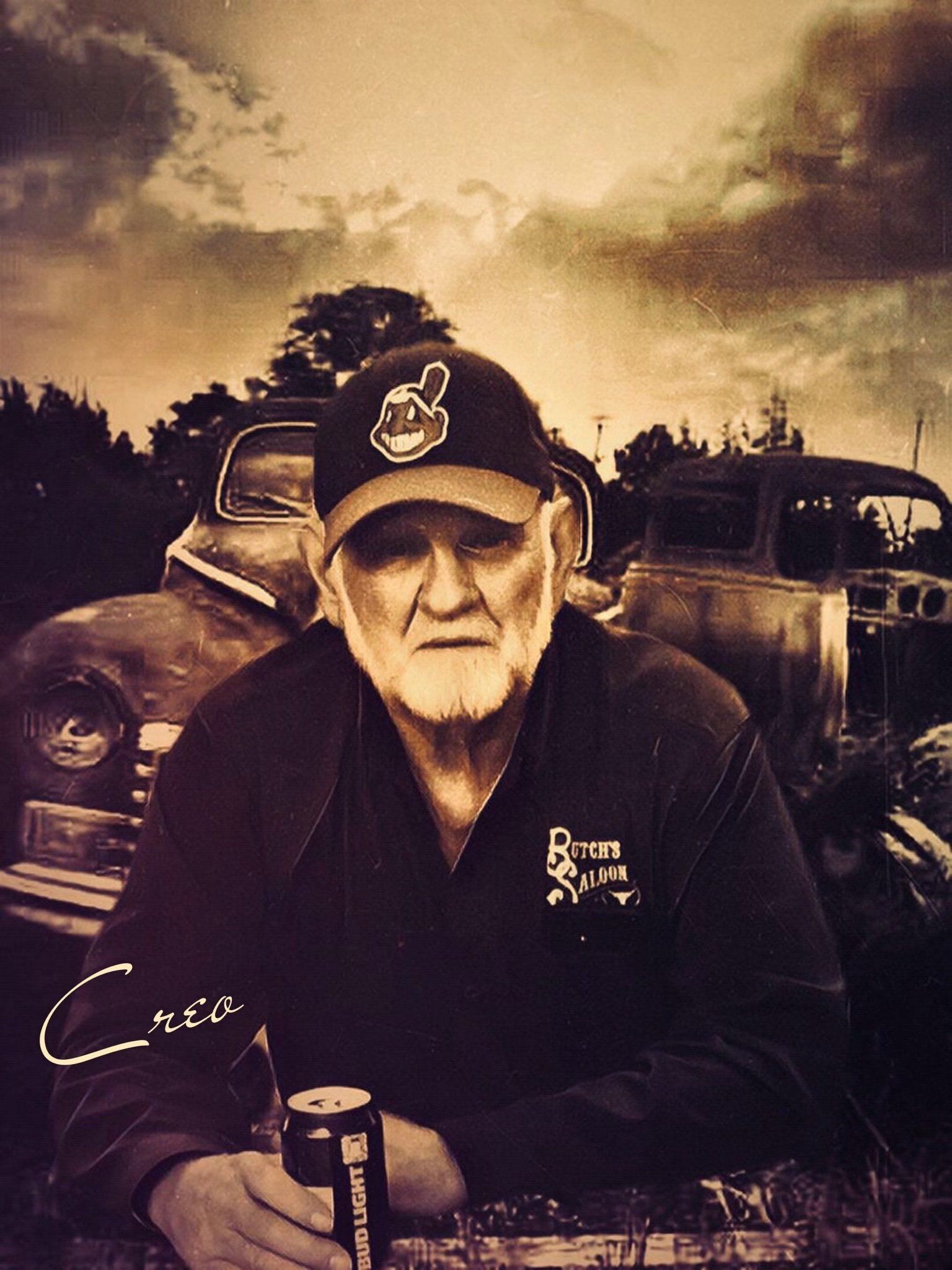 A man with a beard is holding a can of beer