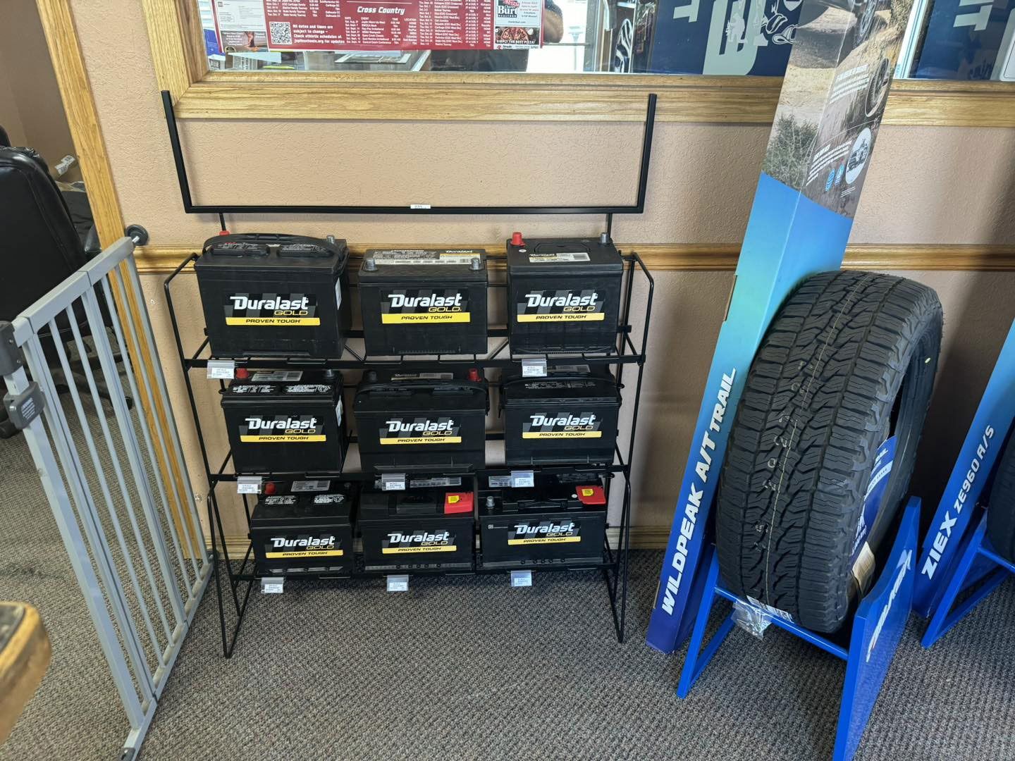 A display of batteries and tires in a store
