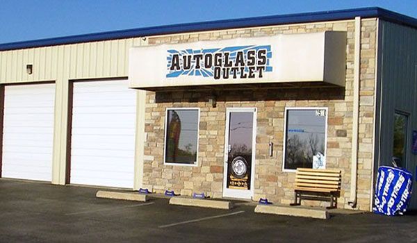 A building with a sign that says autoglass outlet