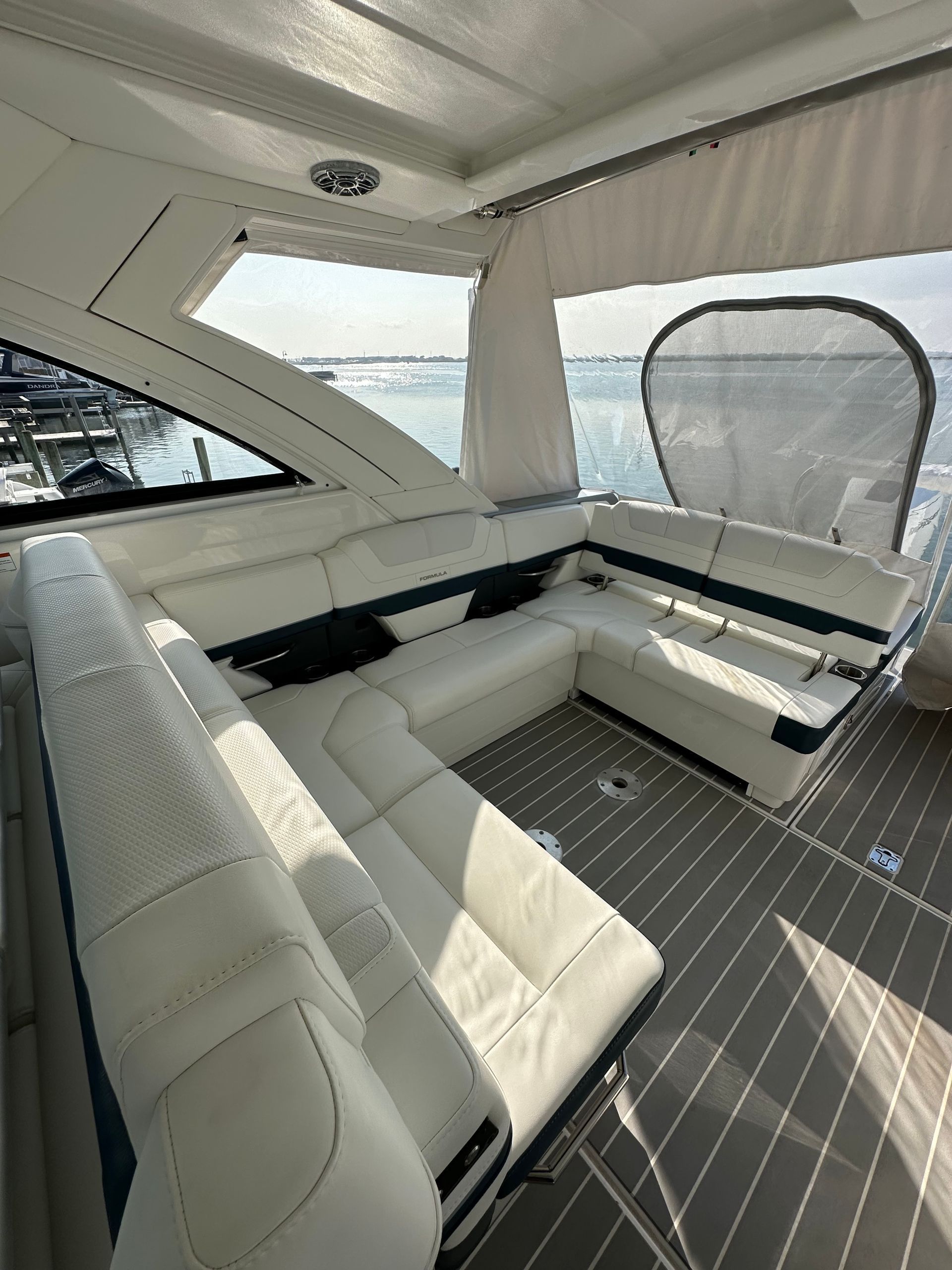the inside of a boat with a couch and a window