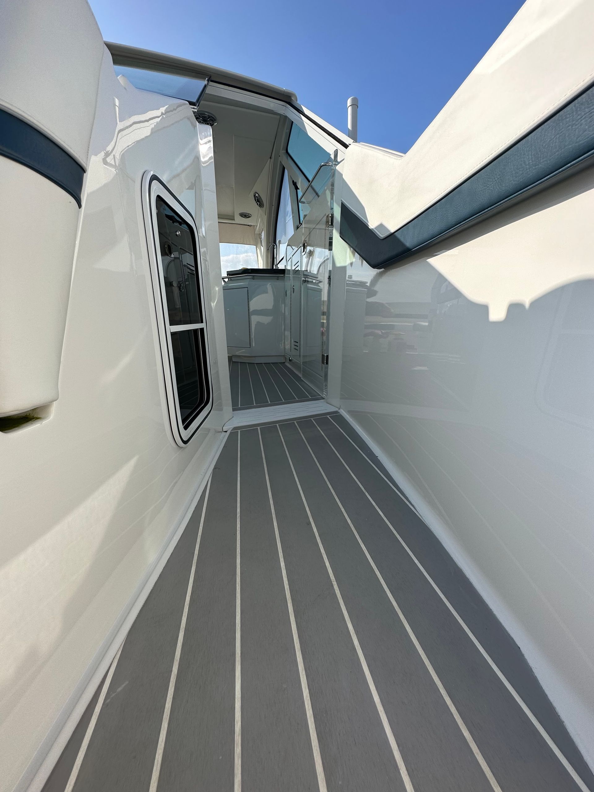a white boat with a gray and white striped floor