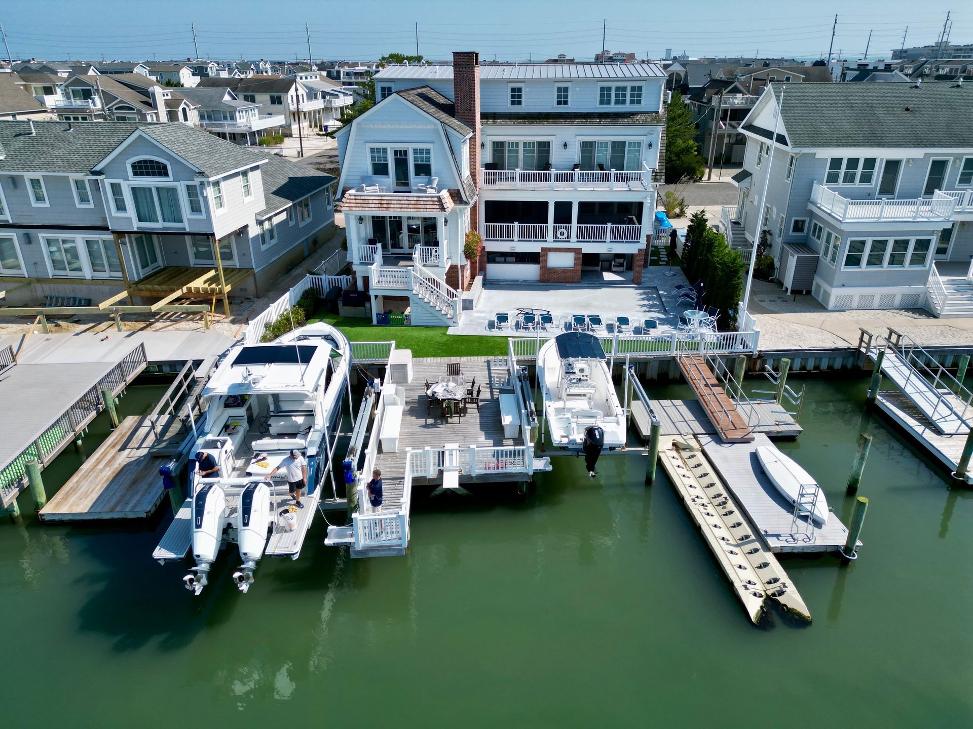 a group of boats are docked in front of a house